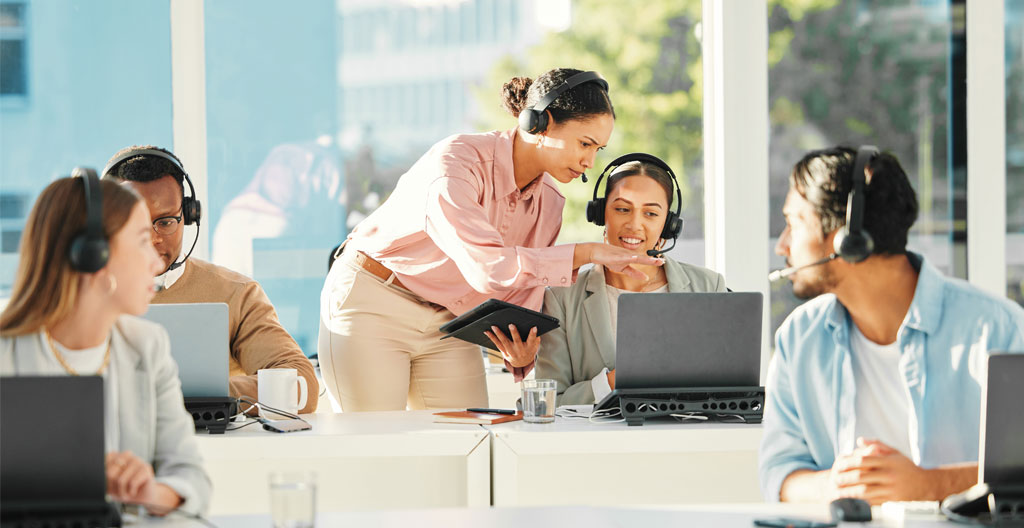 Formateur en closing expliquant des techniques à un petit groupe d'apprenants attentifs dans une salle de formation moderne, tableau blanc avec mots-clés en français